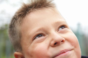 Image showing Boy looking to sky closeup