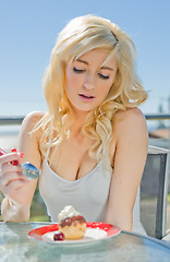 Image showing young woman having dessert