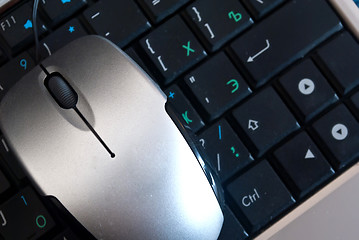 Image showing The mouse is on the keyboard laptop.