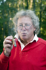 Image showing senior man smoking big cigar