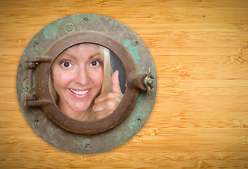 Image showing Antique Porthole on Bamboo Wall, Woman with Thumbs Up Looking