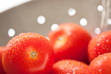 Image showing Fresh, Vibrant Roma Tomatoes in Colander with Water Drops