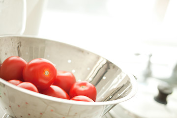 Image showing Fresh, Vibrant Roma Tomatoes in Colander with Water Drops