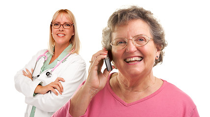 Image showing Senior Woman Using Cell Phone with Female Doctor Behind