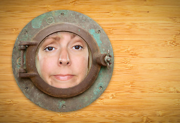 Image showing Antique Porthole on Bamboo Wall with Funky Woman Looking Through