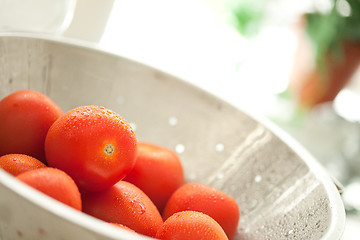 Image showing Fresh, Vibrant Roma Tomatoes in Colander with Water Drops