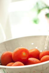 Image showing Fresh, Vibrant Roma Tomatoes in Colander with Water Drops