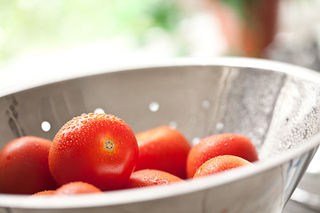 Image showing Fresh, Vibrant Roma Tomatoes in Colander with Water Drops