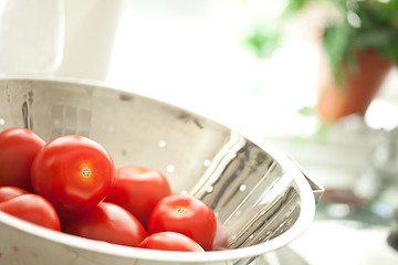 Image showing Fresh, Vibrant Roma Tomatoes in Colander with Water Drops