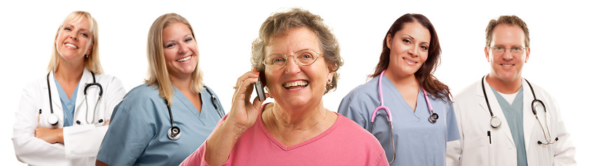 Image showing Happy Senior Woman Using Cell Phone and Doctors Behind