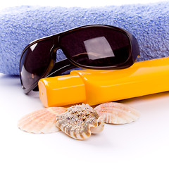 Image showing towel, shells, sunglasses and lotion