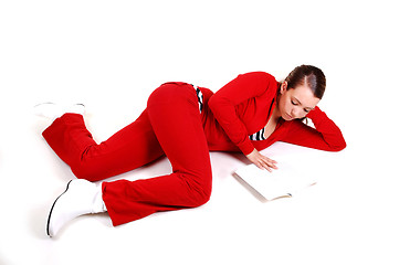 Image showing Girl lying on floor and reading. 