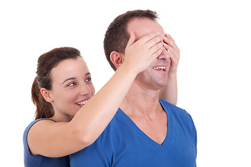 Image showing Portrait of a happy woman covering his man eyes, to surprise him