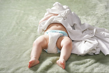 Image showing Baby tagled in bed-sheet