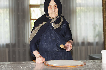 Image showing Elderly woman with rolling pin