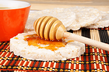 Image showing Honey dipper on a rice cake