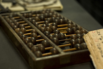 Image showing abacus and book on the table 