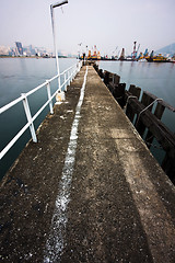 Image showing Deserted jetty at a foggy sea near a dutch city. 