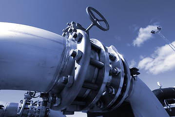 Image showing industrial pipelines on pipe-bridge against blue sky 