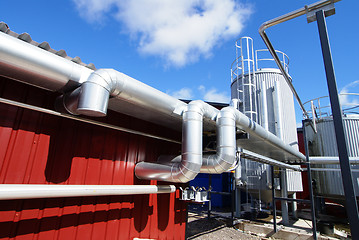 Image showing Industrial zone, Steel pipelines against blue sky        