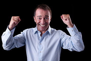 Image showing Portrait of a very happy  businessman with his arms raised