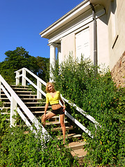 Image showing Lady standing on white wooden steps.