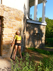 Image showing Blond lady on an stone wall.