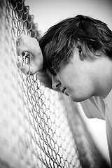 Image showing Teen against fence
