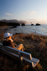 Image showing woman on bench overlooking beach