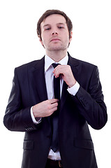 Image showing  man adjusting his tie