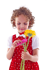 Image showing girl sniffs some flowers