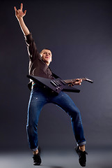 Image showing  guitarist  making a rock gesture 