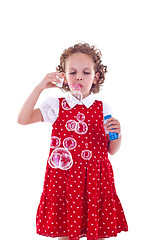 Image showing little girl blowing soap bubbles 