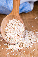 Image showing oat flakes in wooden spoon