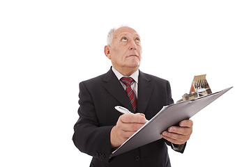 Image showing senior businessman writing