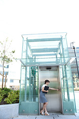 Image showing businesswoman waiting for the elevator