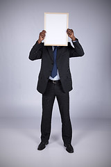 Image showing african businessman holding a whiteboard