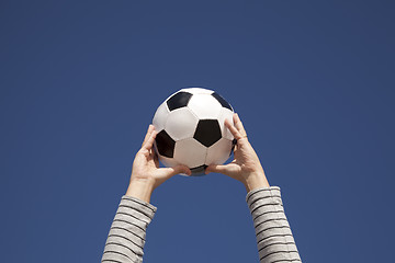 Image showing Hands holding a soccer ball