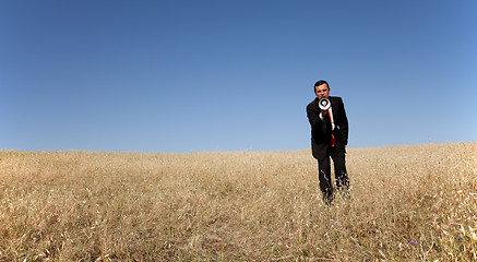 Image showing Businessman shouting at the megaphone to you