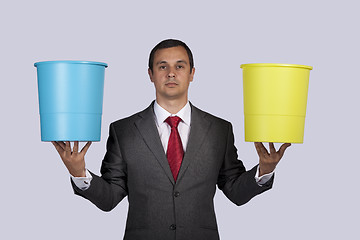 Image showing Businessman holding buckets