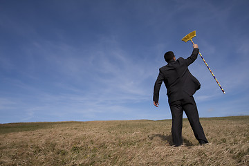 Image showing businessman cleaning the environment