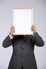 Image showing businessman holding a whiteboard