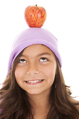 Image showing young child with an apple on her head