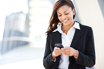 Image showing Black businesswoman texting