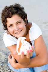 Image showing  woman on seacoast with a cockleshell in hands 