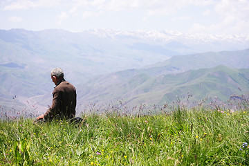 Image showing Praying man kneeling rear view