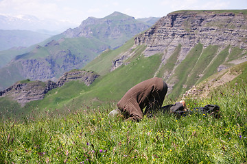 Image showing Praying man making low bow