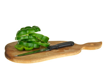 Image showing Cutting board with sliced green bell pepper and knife