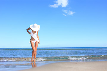 Image showing Young woman standing on a beach 