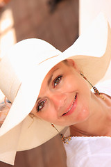 Image showing Woman sitting on sun bed 